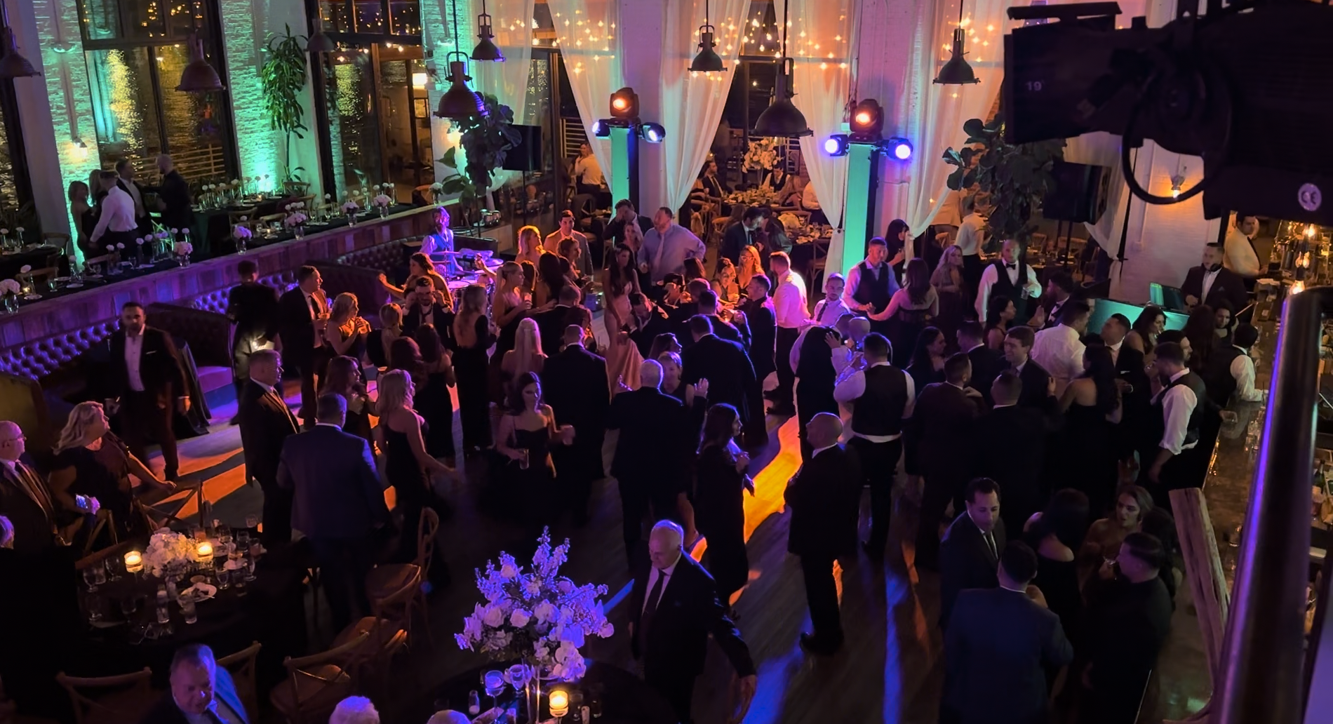 Guests lifting the guest of honor on a chair during a high-energy celebration