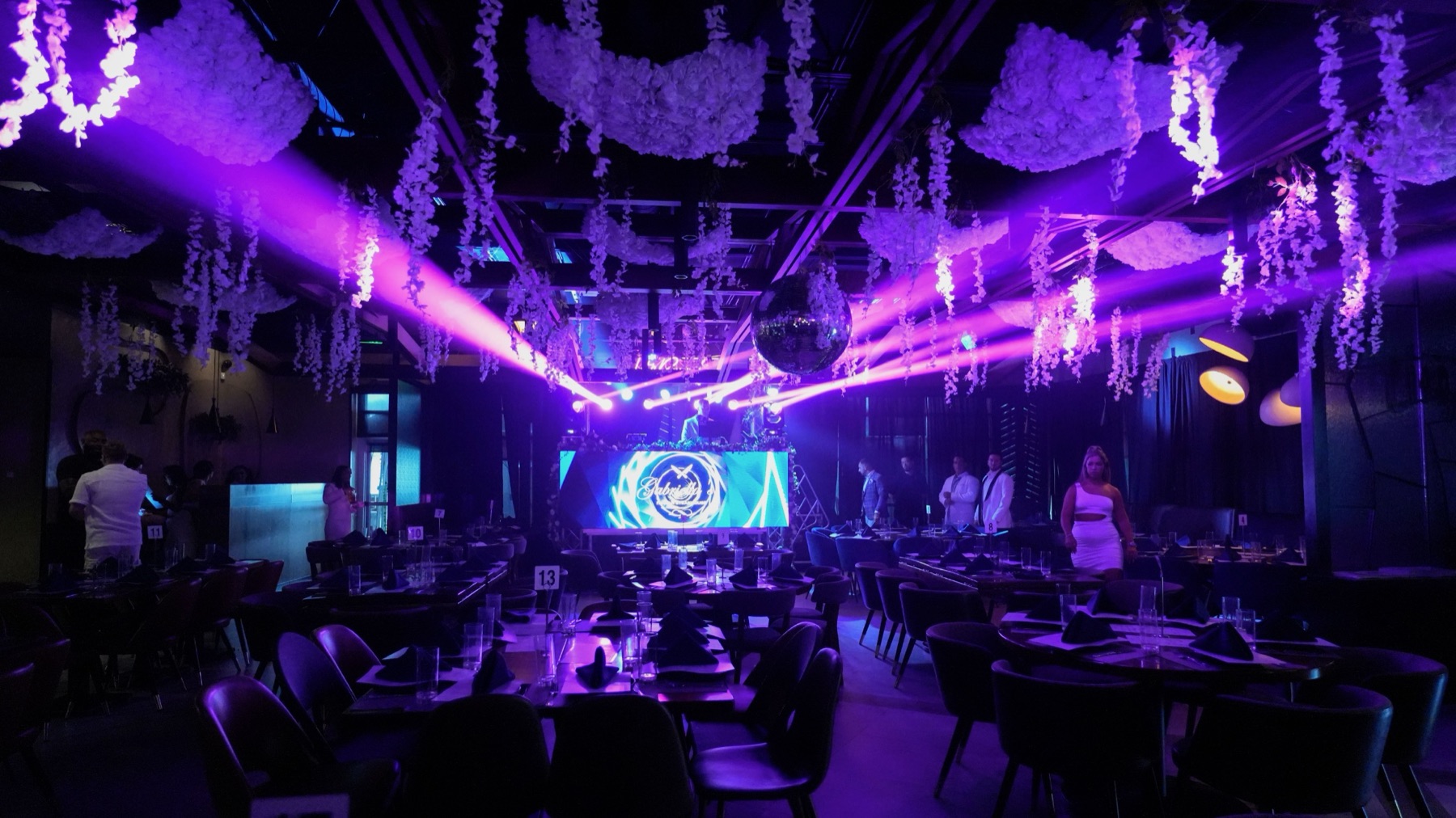 A packed dance floor lit up with glowing lights at a celebration